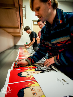 Geoff Graham and the other members of Lower Dens sign several posters (drawn by Baltimore artist Alex Fine) before An Evening With Lower Dens at WTMD (Photo by Steve Parke)