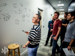 Jana Hunter and the other members of Lower Dens sign the wall before An Evening With Lower Dens at WTMD (Photo by Steve Parke)